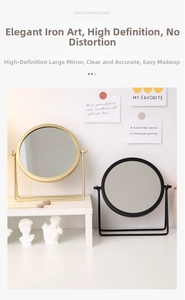 Detail view of round metal desktop makeup mirrors in matte black and champagne gold