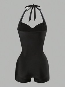Detailed back view of a black halter one-piece swimsuit with lace-up ties and boyleg cut