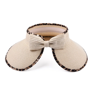 Detail of woven straw sun visor with leopard print trim and a large matching bow