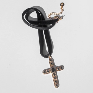 Vintage velvet choker featuring a gold cross pendant with black zircon in a flat lay view