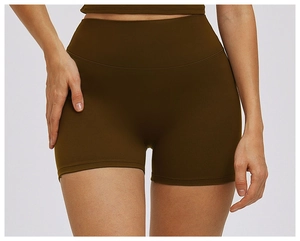 Detail view of high waist yoga shorts featuring seamless sculpting fabric in dark olive