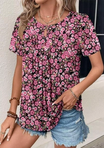 Detailed close-up of floral print short sleeve top with neckline cutout and vibrant pattern