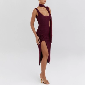 Detail of burgundy slit dress with 3D floral accents and elegant mesh draping