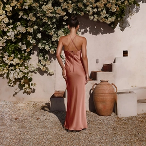 Detail of copper satin backless dress with crisscross straps and slim fit design