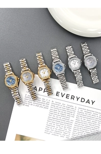 Detail of luxury women's quartz watches with rhinestone bezel and mother of pearl dial