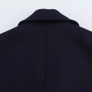 Detailed close-up of the back seam and collar stitching on a wool coat
