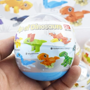 Close-up of DIY dinosaur building block egg capsule toy packaging showing parts