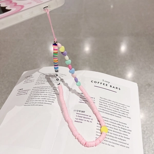 Macro detail of dopamine-style colorful heart beads and LOVE lettering phone wrist strap