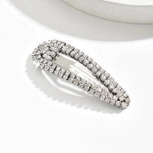Detailed view of teardrop metal hair clip with sparkling rhinestones in silver finish