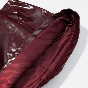 Dettaglio ravvicinato della vita della giacca in pelle PU bordeaux con cuciture
