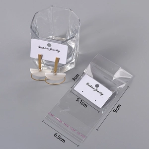 White fashion jewelry card with ear stud display and transparent packaging bag set