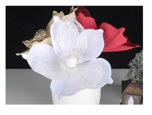 Detail of white glitter poinsettia flower with red and gold hollow petals for Christmas