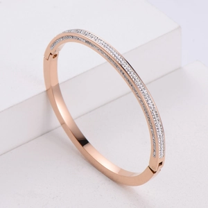 Detail of 18K rose gold plated four-row hinged bangle with pavé-set sparkling diamonds