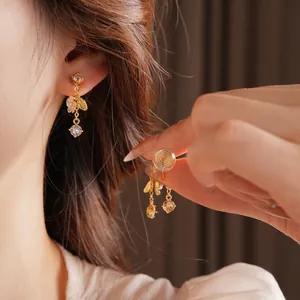 Elegant gold plated floral tassel clip-on earrings with crystals and leaf detail