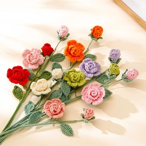 Flat lay of handmade crochet rose bouquet in vibrant red, pink, and yellow colors