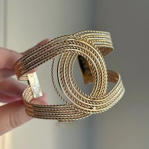 Macro shot of gold-plated twisted rope cuff bracelet with interlocking C shape design