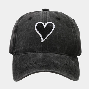 Close-up of vintage washed cotton baseball cap featuring embroidered heart patch details