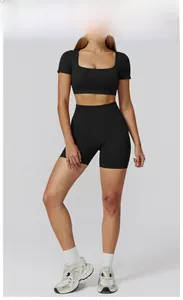 Detail of seamless black fitness yoga set featuring square neck crop top and high waist shorts