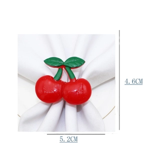 Detail view of a cherry-shaped napkin ring with dimensions of 4.6cm by 5.2cm