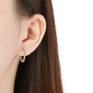 Classic silver bead ring earrings in stainless steel on a model's earlobe
