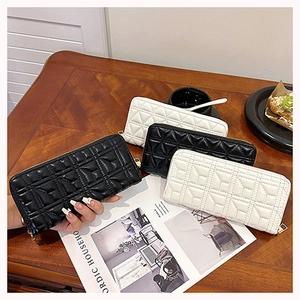 Close-up of elegant quilted leather long wallets for women in black and white styles