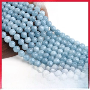 Macro shot of natural light blue stone beads with organic mineral texture for DIY jewelry