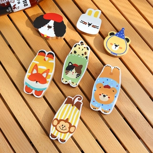 Set of seven cartoon animal wooden coasters including dog and rabbit on a wooden table