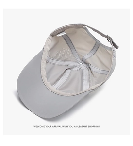 Detail of breathable white mesh lining and grey quick-dry fabric on sports baseball cap