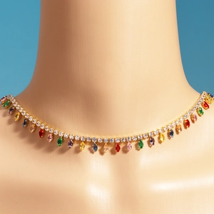 Detail of model wearing a gold plated necklace with colorful teardrop zircon pendants