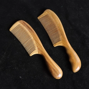 Natural sandalwood comb set with straight and curved handles featuring rich wood grain texture