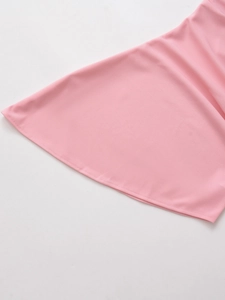 Detailed close-up of pink ruched fabric texture and precision hem stitching on the garment