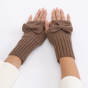 Close-up of brown knit fingerless gloves with bow detail and soft wool texture
