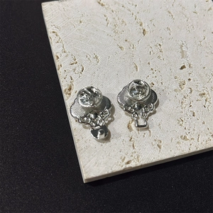 Detail view of the silver metal pin backing and butterfly clasp assembly of the brooch