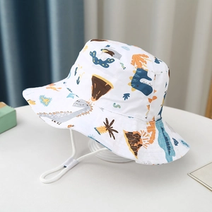 Close-up of children's white bucket hat with colorful dinosaur prints and adjustable chin strap
