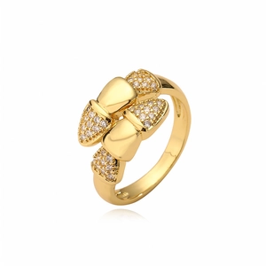 Gold-plated ring with a bow-shaped design and sparkling cubic zirconia stones