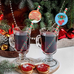 Detail of Christmas themed straws with Merry Christmas text and festive paper cards