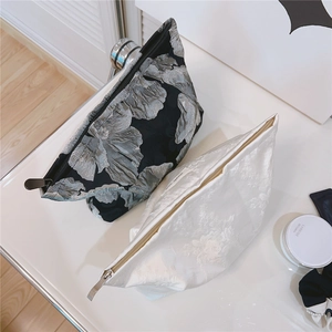 Close-up of jacquard fabric texture and metal zipper on these stylish cosmetic bags
