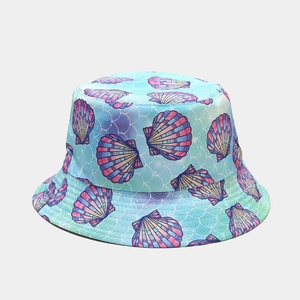 Detailed view of the seashell print and fish scale texture on the blue bucket hat