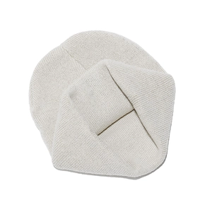 Detail of soft cream white knit material with a unique twist design on a winter beanie hat