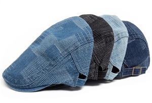 Detail view of denim flat caps in multiple colors featuring metal adjustable buckles