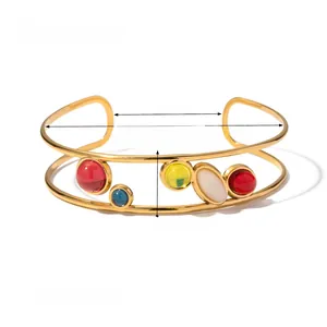 Detailed view of gold plated double band cuff bracelet with colorful gemstone accents