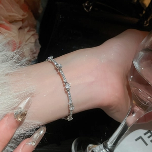 Close-up of sparkling cubic zirconia silver bracelet with heart-shaped stones on wrist