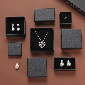 Minimalist black textured jewelry box collection with luxury pearl earrings and necklaces