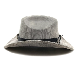 Detail of grey woven cowboy hat featuring a black decorative band and textured finish