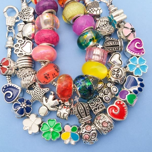 Close-up of colorful glass beads and silver charms for DIY jewelry bracelets