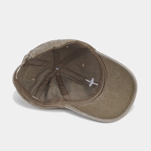 Internal details of brown washed cotton baseball cap with reinforced seams and metal buckle