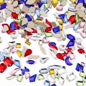 Mixed shape nail art rhinestones featuring colorful hearts, stars, and moon gems on white