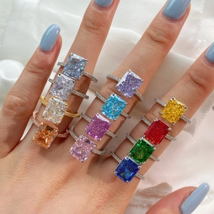 Macro shot of colorful cushion cut cubic zirconia rings on model's hand with silver bands