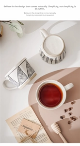 Top view of handmade ceramic mugs with hand-painted geometric patterns and wide handles