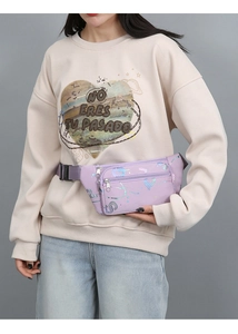Detail view of light purple waist bag with adjustable strap and iridescent pattern